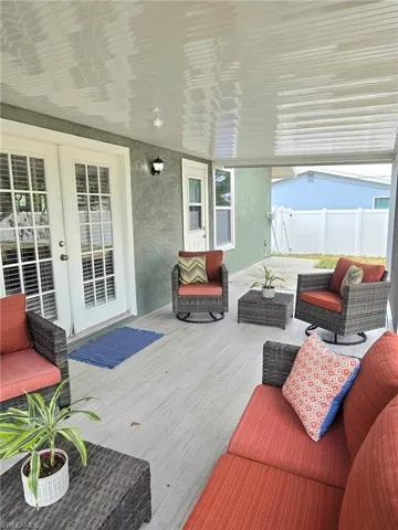 Wooden terrace featuring french doors, fence, and outdoor lounge area