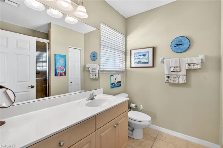 Bathroom with vanity, light tile patterned floors