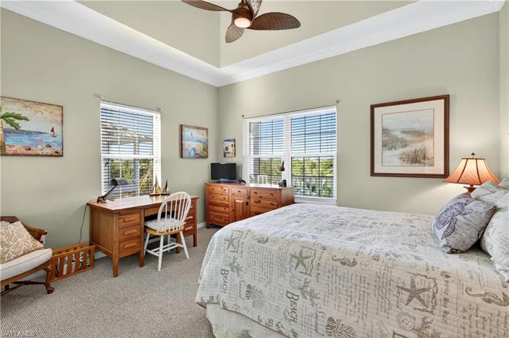 Bedroom with crown molding, light carpet, and ceiling fan