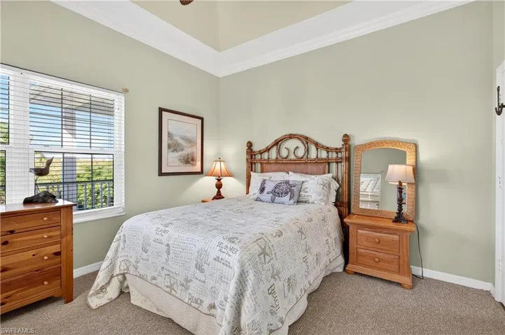 Bedroom with carpet, ornamental molding, and ceiling fan