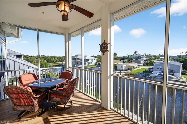 Screened in lanai with water view, and ceiling fan