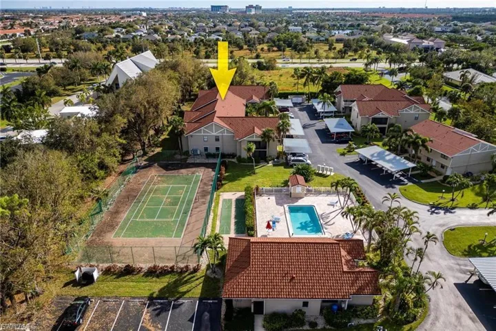 Aerial view of residential area featuring a pool area