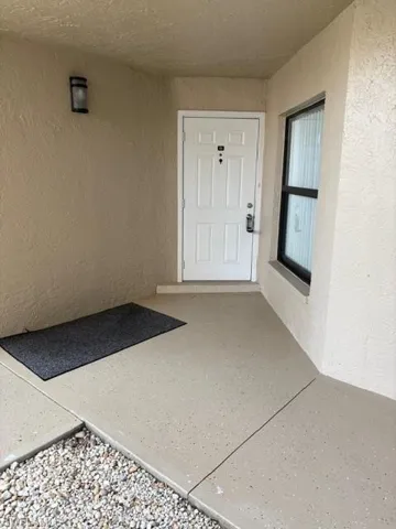 Property entrance with stucco siding
