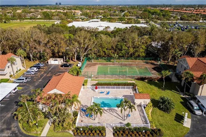 Aerial view of a pool area and a tree filled landscape