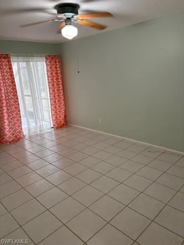 Unfurnished room with a ceiling fan and light tile patterned flooring
