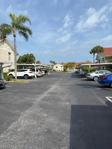 Partially covered parking lot with a residential view