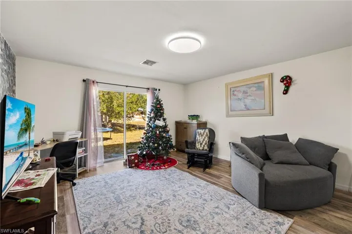Living room with light hardwood / wood-style floors