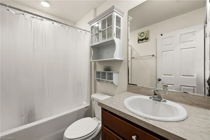 Full bathroom with vanity, toilet, and shower / tub combo