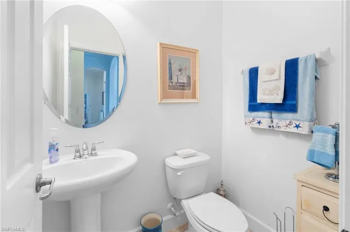 Bathroom featuring baseboards and toilet