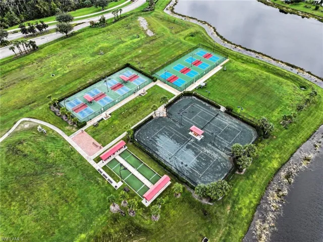 Recreational complex featuring multiple tennis courts, pickleball courts, and a bocce ball court situated on landscaped grounds