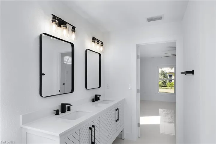 Bathroom with vanity and ceiling fan