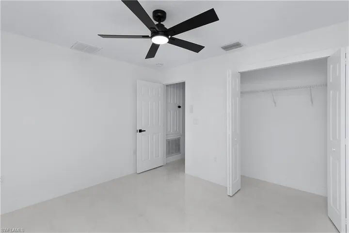 Unfurnished bedroom with a closet and ceiling fan