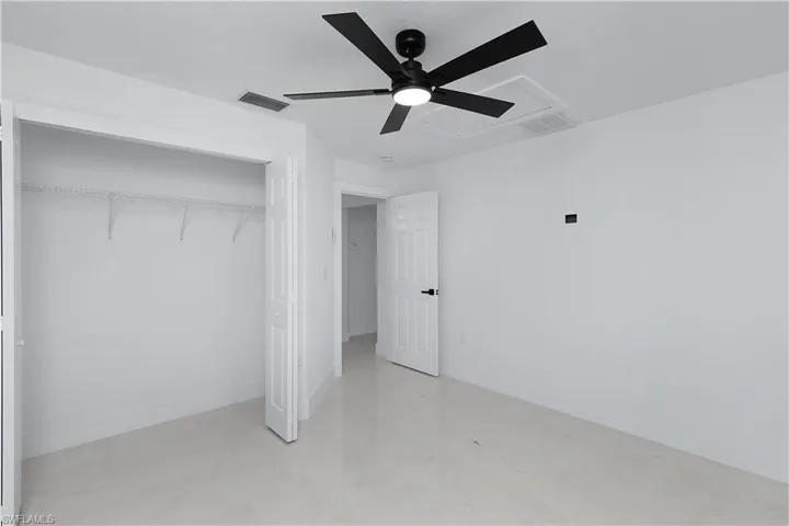 Bedroom featuring ceiling fan and a closet