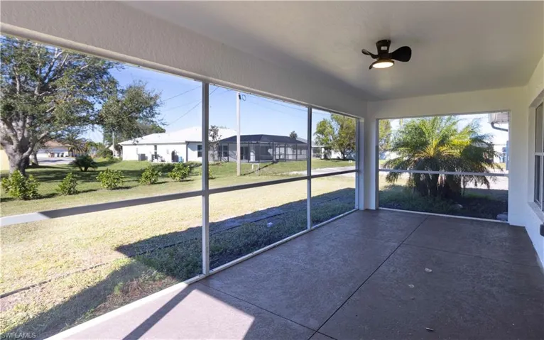 Unfurnished sunroom featuring a wealth of natural light and ceiling fan
