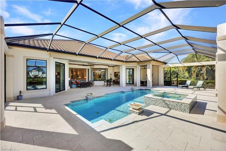 Gas heated pool with motorized hurricane screens to protect the covered seating and built in surround sound