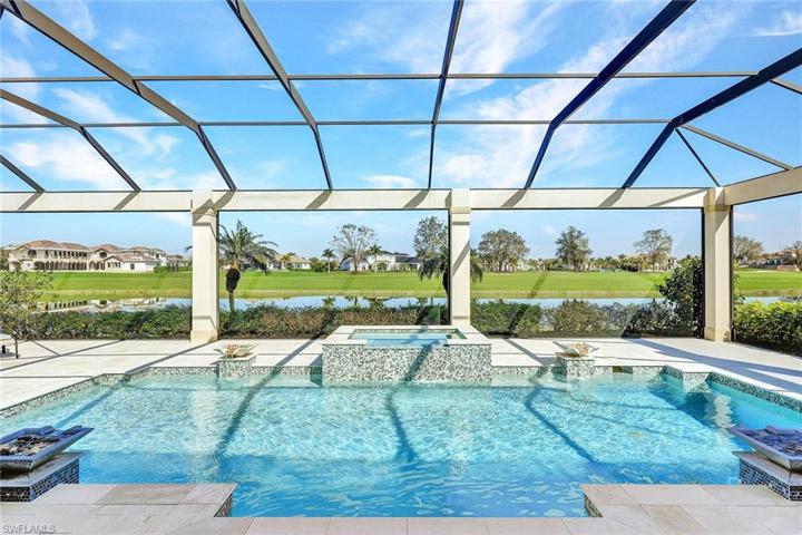 Generous outdoor living: 32’ pool & spillover spa in a 62’ wide picture window concrete framed pool enclosure