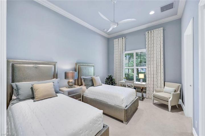 Guest bedroom can fit  2 beds and a desk, offers custom window coverings and plantation shutters