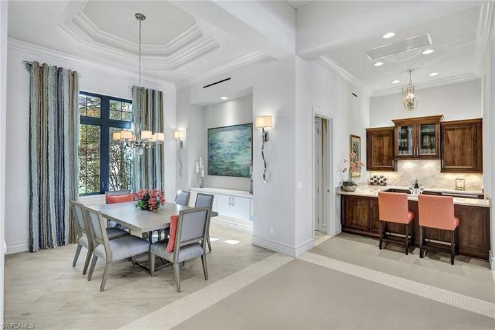 Dining is adjacent to a wet bar offering a wine cooler, icemaker and two refrigerator drawers
