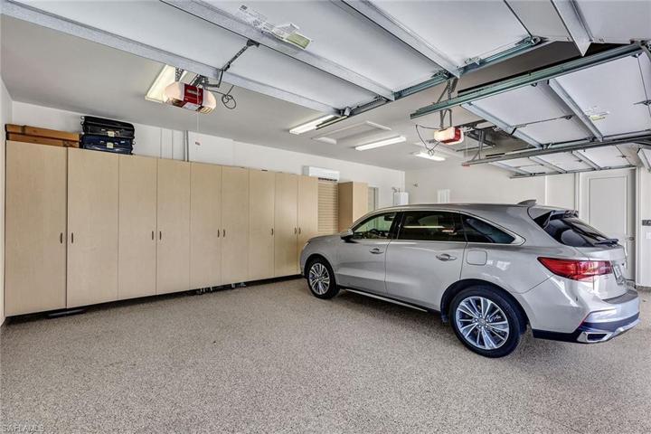 Air conditioned oversized 3 car garage with custom storage wall and whole house generator.