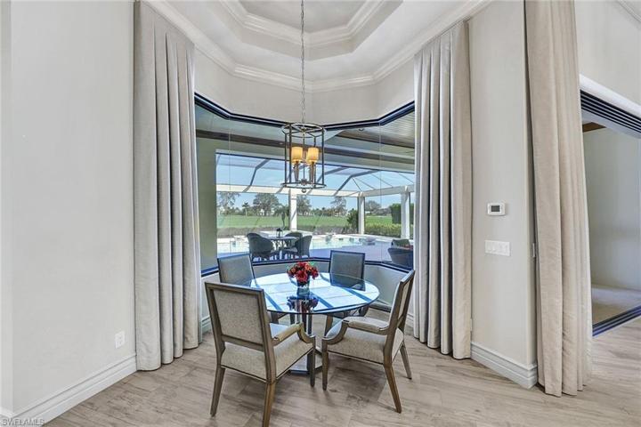 Casual Dining with seamless windows commands a view of the pool, golf course and lake
