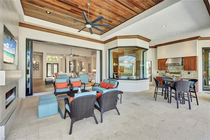 Outdoor natural gas fireplace with TV creates a serene ambience for morning coffee and afternoon cocktails