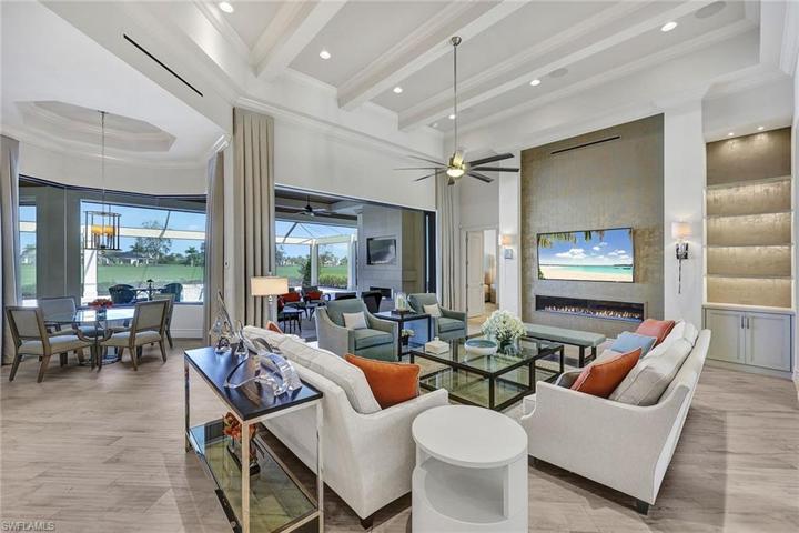 Stunning open great room is graced by a natural gas fireplace and lighted built in display niche