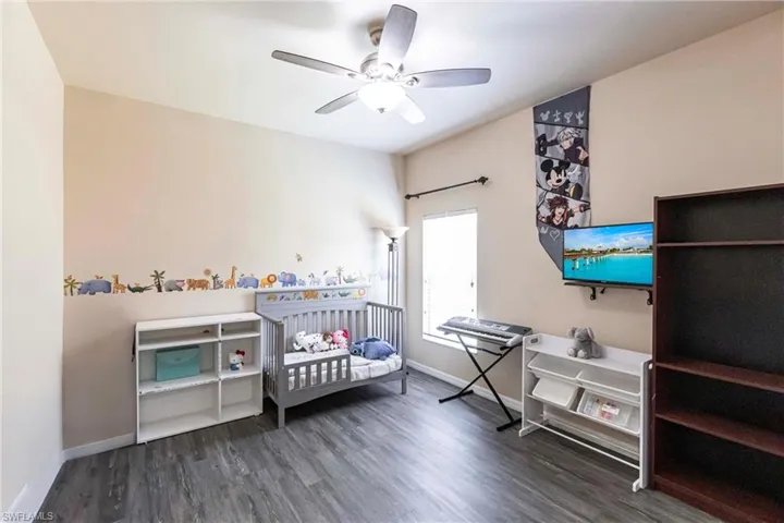 Bedroom with baseboards, ceiling fan, and wood finished floors