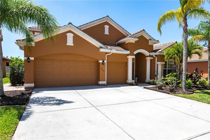 Mediterranean / spanish-style home with an attached garage, stucco siding, a tiled roof, and concrete driveway