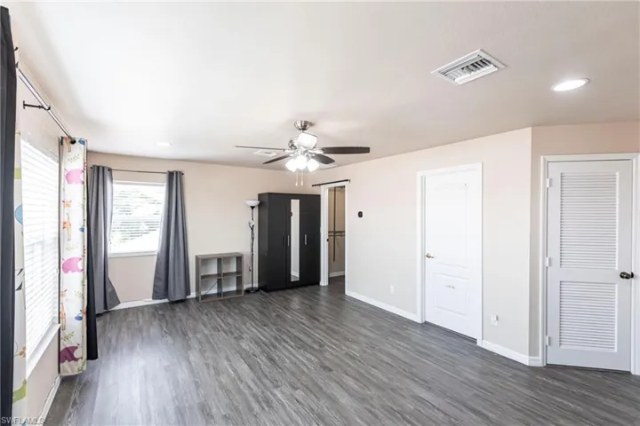 Unfurnished living room featuring visible vents, wood finished floors, baseboards, recessed lighting, and a ceiling fan