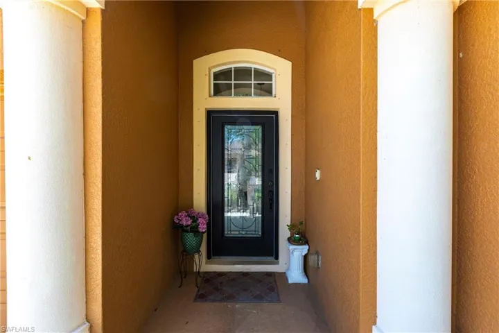 Doorway to property with stucco siding