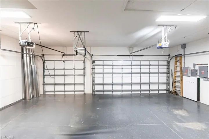 Garage featuring a garage door opener and electric panel