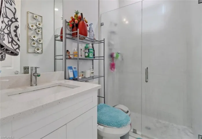 Full bath with vanity and a stall shower