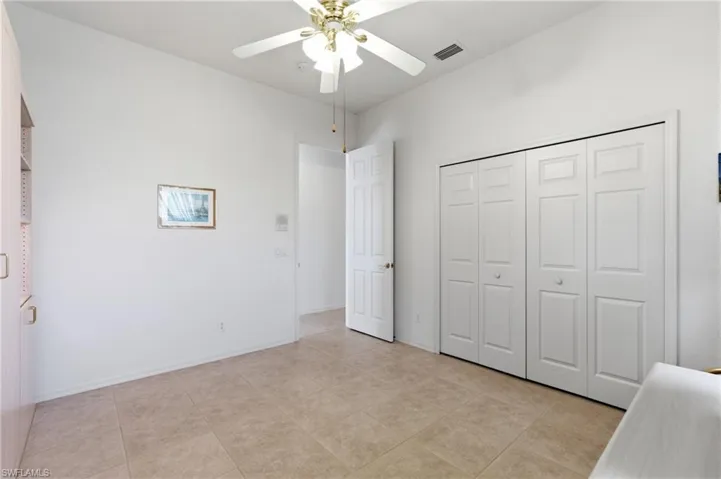 Unfurnished bedroom featuring ceiling fan and a closet