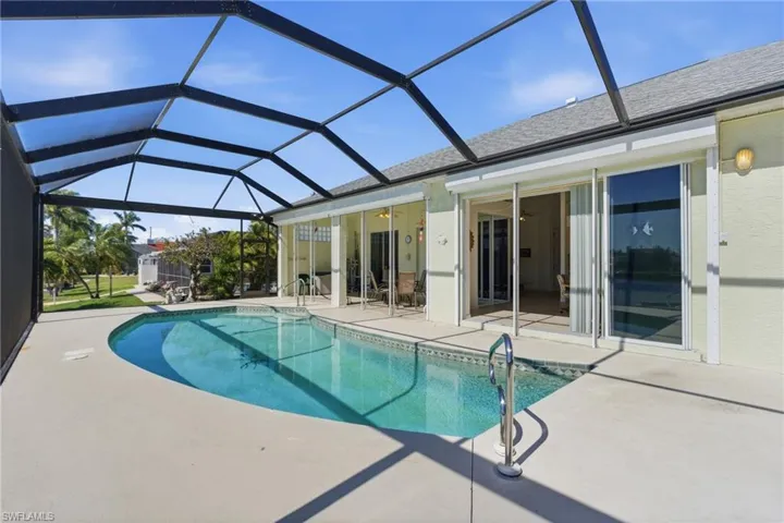 Outdoor pool featuring a patio area, a sunroom, and a lanai