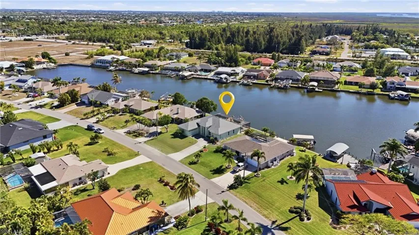 Aerial perspective of suburban area with a nearby body of water