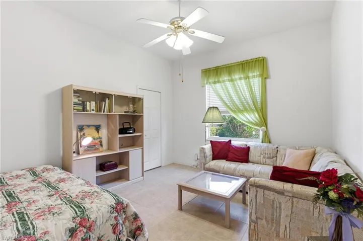Bedroom featuring ceiling fan and light tile patterned flooring