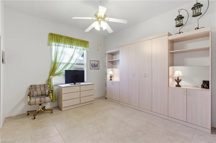 Unfurnished bedroom with a closet, ceiling fan, and light tile patterned flooring