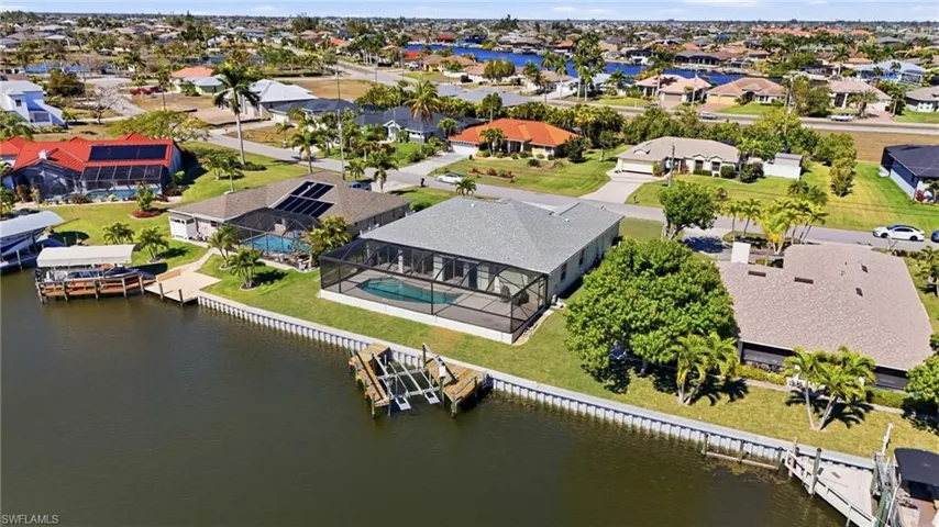 Aerial perspective of suburban area with a nearby body of water