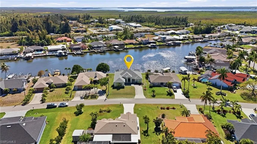 View of property location featuring a large body of water and nearby suburban area