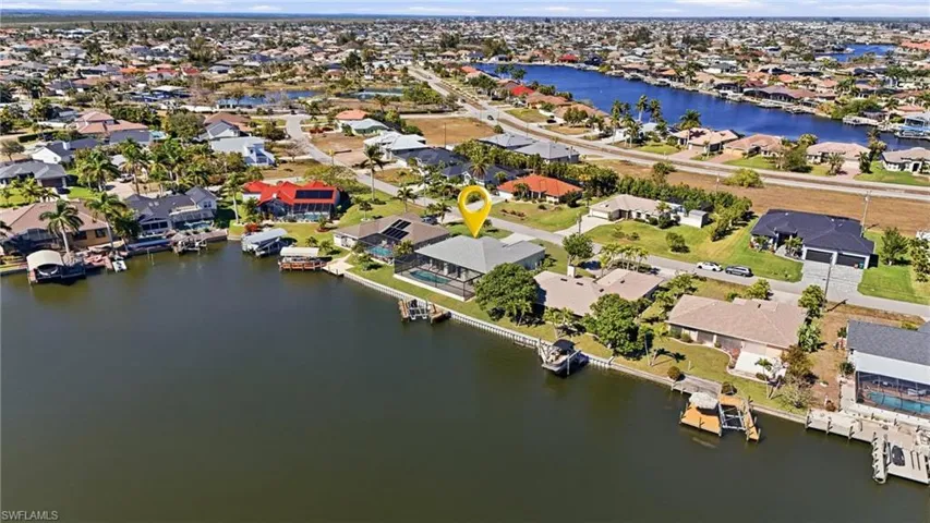 View of property location featuring a nearby body of water and nearby suburban area