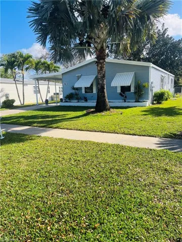Charming Manufactured with inviting curb appeal and lush landscaping.
