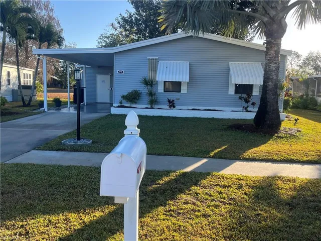 Welcoming front exterior with private driveway and mature landscaping.