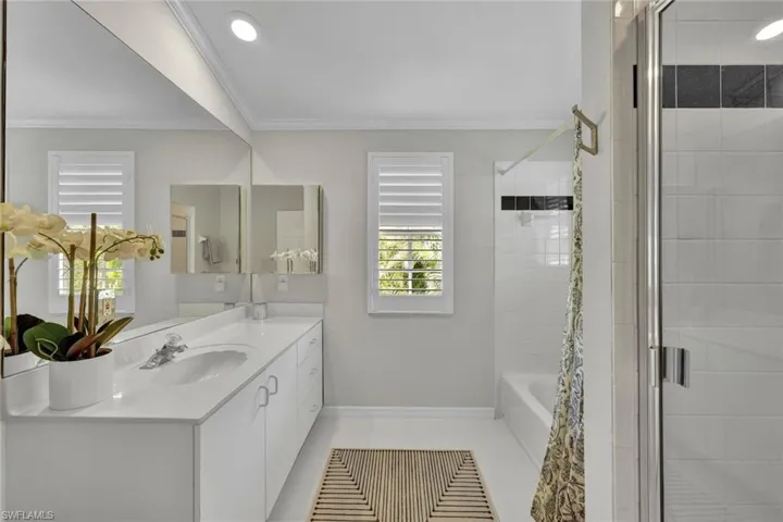 Bathroom featuring independent shower and bath, ornamental molding, tile patterned floors, and vanity