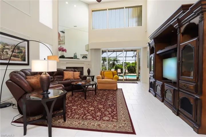 Tiled living room featuring a high ceiling