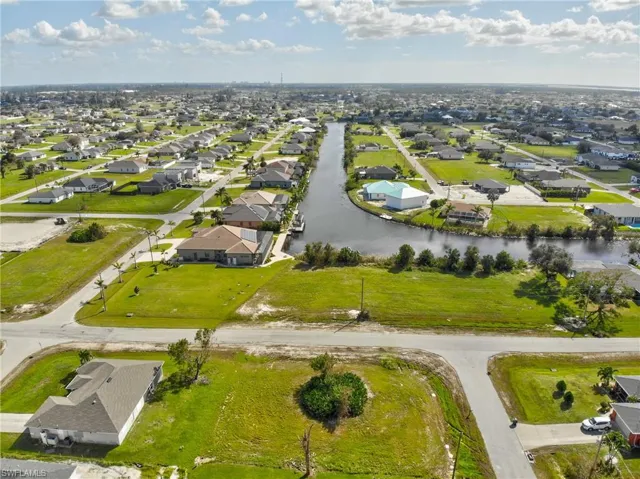 Birds eye view of property with a water view