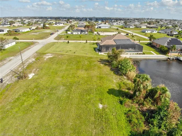 Birds eye view of property with a water view