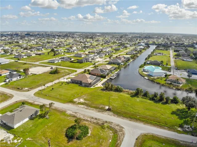 Birds eye view of property with a water view