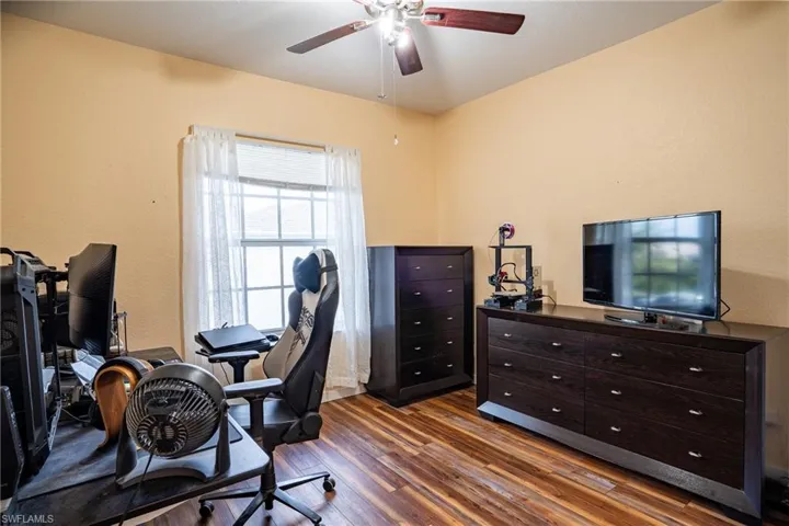 Office area featuring ceiling fan and dark hardwood / wood-style floors