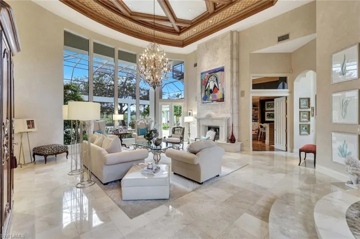 Graced by a Keystone Fireplace, Spectacular Chandelier and Travertine Floors, this home will catch your breath in Bay Colony