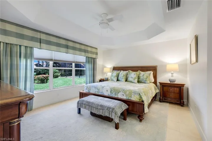 huge master bedroom with large view of lake